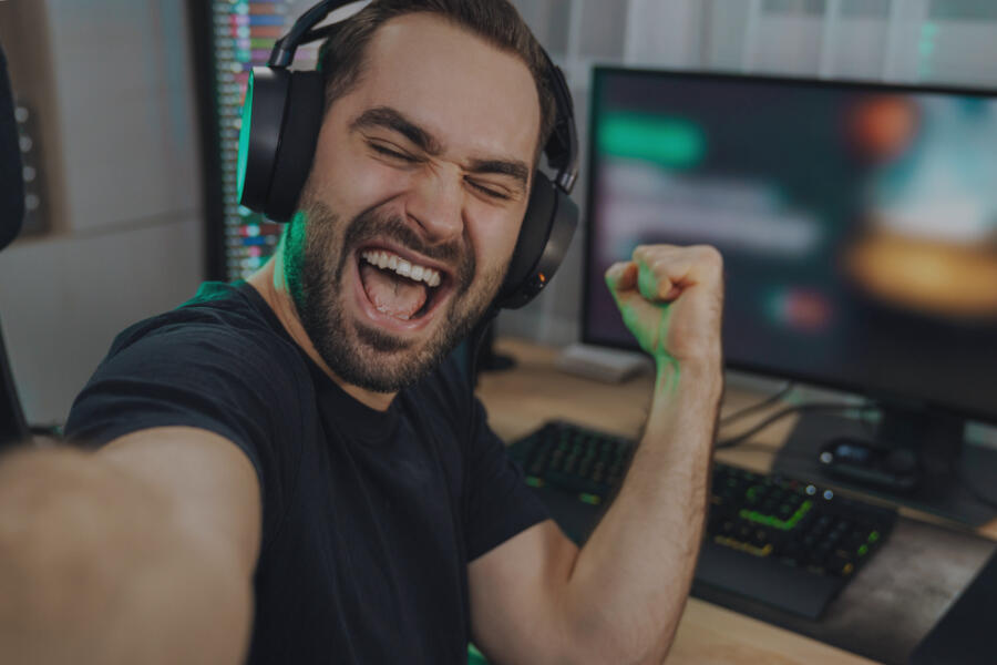 Young man pumping fist at computer